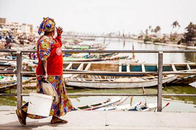 photograph of woman by harbour in Senegal