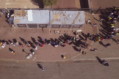 Photo of overhead view of people queuing for a health facility in South Africa during Covid