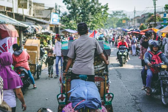 Man on a vehicle in a market